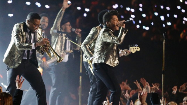 After a children's choir opened the show, Mars and his band perform the smash hit "Locked Out of Heaven."