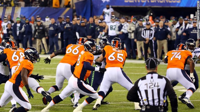 Denver makes a disastrous start as the ball sails over Peyton Manning from a snap which leads to a safety and points on the board for Seattle. 