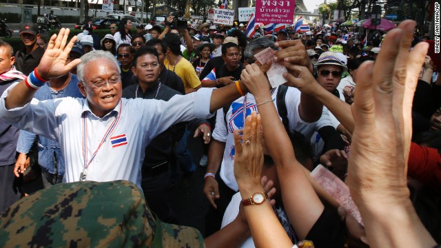 Protest leader Suthep Thaugsuban greets supporters during a march in Bangkok, Thailand, on Monday, February 3. Anti-government protesters disrupted voting in roughly one-fifth of Thailand's electoral districts in national elections Sunday, February 2, authorities said.