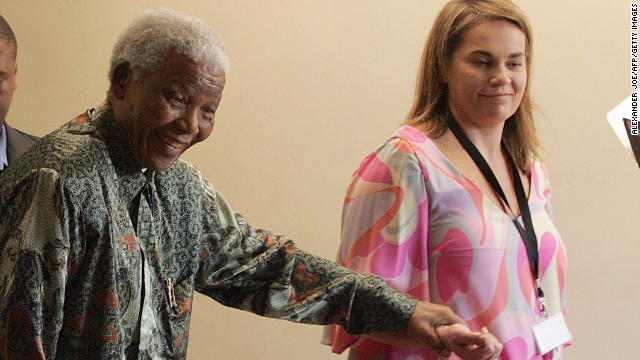 In this file photo, Nelson Mandela leaves his office in Johannesburg with Mandela Rhodes Foundation spokeswoman Zelda la Grange. Nine former staffers, including Le Grange, will receive 50,000 rand each.