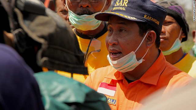 The Head of Search and Recuse for the North Sumutra providence Mr. Romali briefs his team before they head out on their daily search efforts. "We are screening and searching areas that we believe have victims," he tells us. "By using GPS, even if fresh ash falls, we will know where to come back to search for bodies."