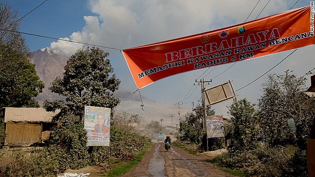 A banner shows the start of a 5 km exclusion zone around the volcano. Many people from villages closer to the summit continue to venture inside this zone. The 15 people killed on Saturday were from one of these villages. 