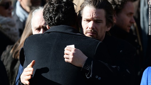 Actor Ethan Hawke hugs another mourner after the service. 