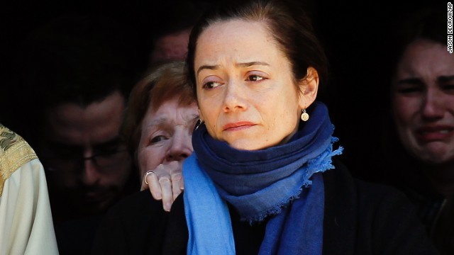 Hoffman's longtime partner, Mimi O'Donnell, watches Hoffman's casket as it is loaded into the back of a hearse.