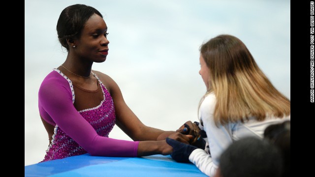 France's Mae Berenice Meite receives last-minute encouragement before the women's short program portion of the team figure skating event February 8.
