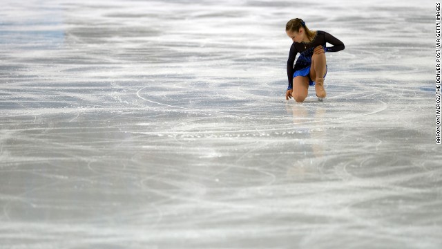 Russia's Julia Lipnitskaia runs her fingers across the ice February 8 as she competes in the women's short program during the team figure skating event. 