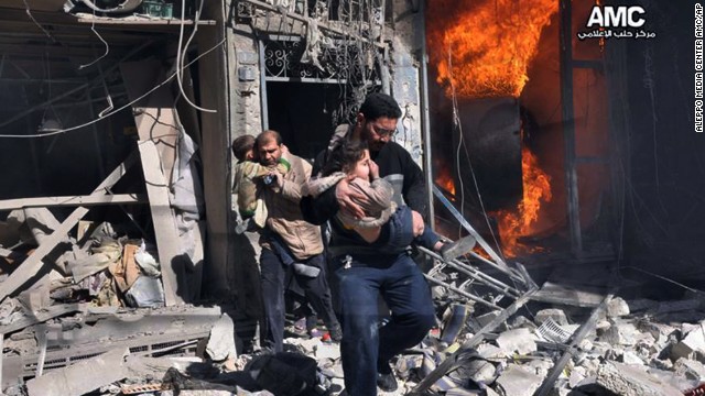 In this photo provided by the anti-government activist group Aleppo Media Center, Syrian men help survivors out of a building in Aleppo after it was bombed, allegedly by a Syrian regime warplane on Saturday, February 8.