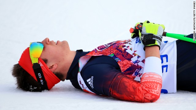 Callum Smith of Great Britain rests at the finish line of the men's skiathlon.