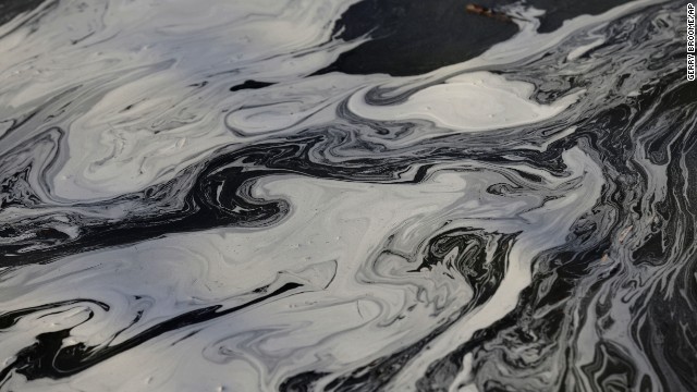 Coal ash swirls on the surface of the Dan River on Wednesday, February 5, as state and federal environmental officials continue their investigation of a spill of coal ash into the river near Danville, Virginia. Duke Energy estimated that up to 82,000 tons of ash had been released from a break in a 48-inch storm water pipe at the Dan River power plant in Eden, North Carolina. 