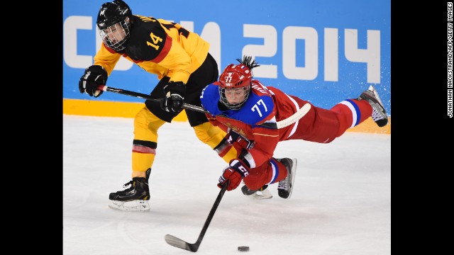 Germany's Jacqueline Janzen, left, vies with Russia's Inna Dyubanok during a women's ice hockey match on February 9. 