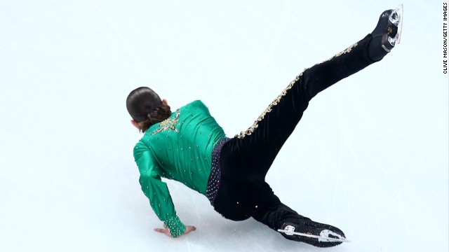 Jason Brown of the United States falls February 9 while competing in the men's free skate portion of the team figure skating event.