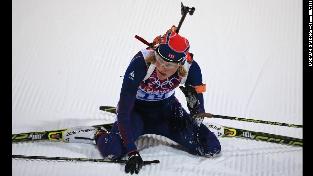 Biathlete Tora Berger of Norway collapses at the end of the women's 7.5-kilometer sprint.
