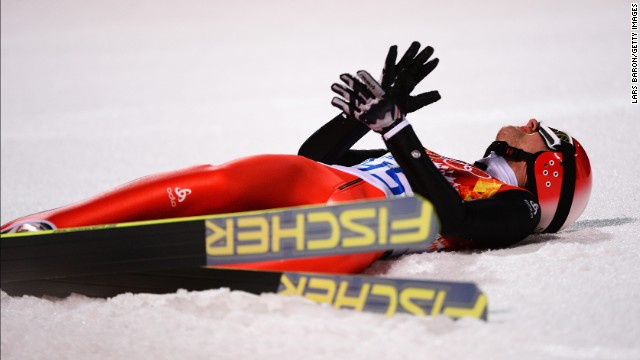 Simon Ammann of Switzerland reacts after landing his final jump in the men's normal hill ski jumping event February 9.