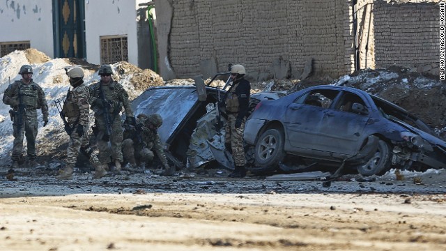 U.S. soldiers and Afghan security forces search the site of a suicide bombing in Kabul, Afghanistan, on February 10, 2014. 