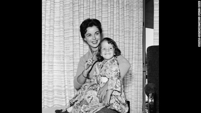 Temple Black sits with her daughter Lori Black at their home in 1957.