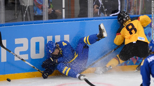 Sweden's Jenni Asserholt falls after missing a hit on Germany's Julia Zorn during their ice hockey match on February 11.