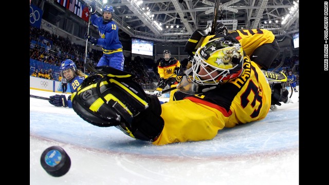 Michelle Lowenhielm of Sweden scores against Jennifer Harss of Germany in the third period of their hockey game on February 11.