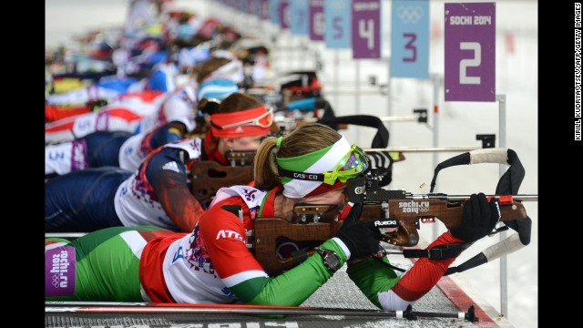 Belarussian biathlete Darya Domracheva, foreground, shoots during the women's 10-kilometer pursuit on February 11.