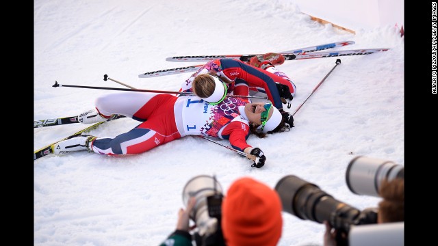 Norway's Ingvild Flugstad Oestberg, top, and Maiken Caspersen Falla celebrate after finishing second and first, respectively, in the women's cross-country sprint on February 11.