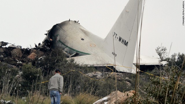 A man surveys the damage after a military plane crashed in the mountains of eastern Algeria on Tuesday, February 11. Rescue workers recovered at least 77 bodies and found one survivor, officials said.