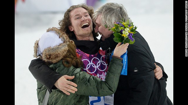 Swiss snowboarder Iouri Podladtchikov celebrates with his parents, Yurii and Valentina, after winning gold in the halfpipe on February 11.