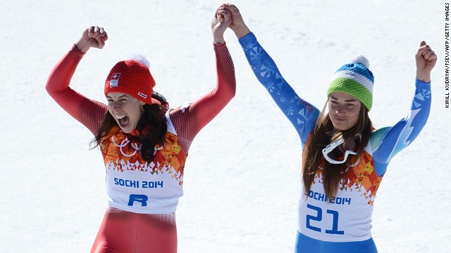Dominique Gisin of Switzerland, left, and Tina Maze of Slovenia stand on the podium together after tying for the gold medal in the women's downhill February 12. The two skiers both finished their run with a time of 1:41.57.