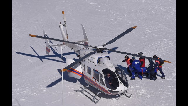 Monaco's Alexandra Coletti is taken to a helicopter after crashing during the downhill.