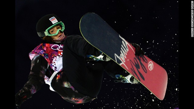 Sarka Pancochova of the Czech Republic grabs her snowboard in the halfpipe event February 12.