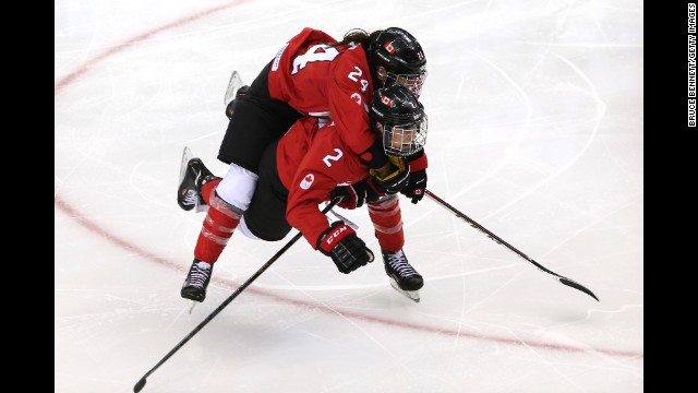 Canadians Natalie Spooner, top, and Meghan Agosta-Marciano celebrate Spooner's third-period goal against the United States on February 12.