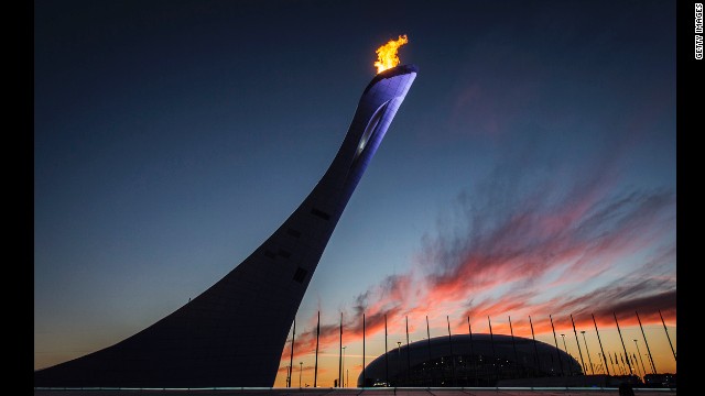 The Olympic cauldron blazes in front of the Bolshoy Ice Dome at sunset February 12.