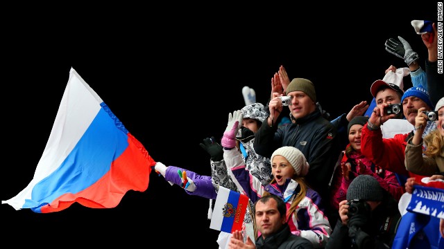 A fan waves a Russian flag after the luge doubles on February 12.
