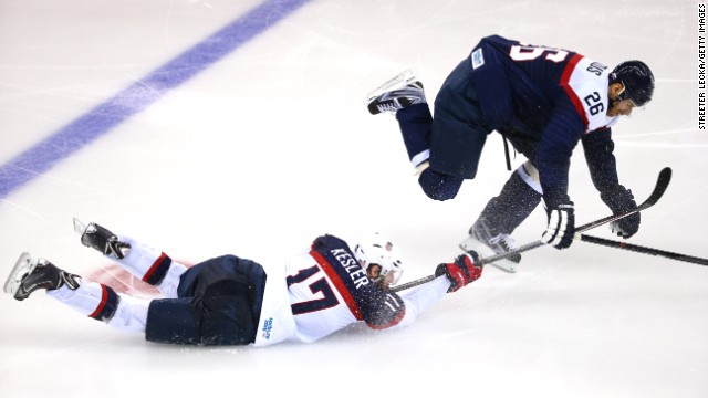 Ryan Kesler of the United States battles Slovakia's Michal Handzus for the puck during their men's hockey game on Thursday, February 13.