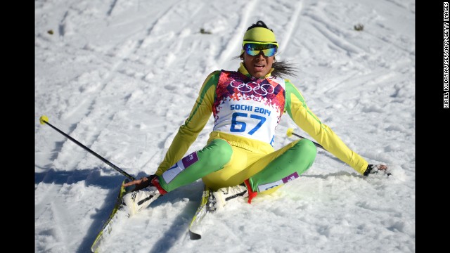 Cross-country skier Mathilde Amivi Petitjean of Togo sits in the snow after crossing the finish line in the women's 10-kilometer classic on February 13.