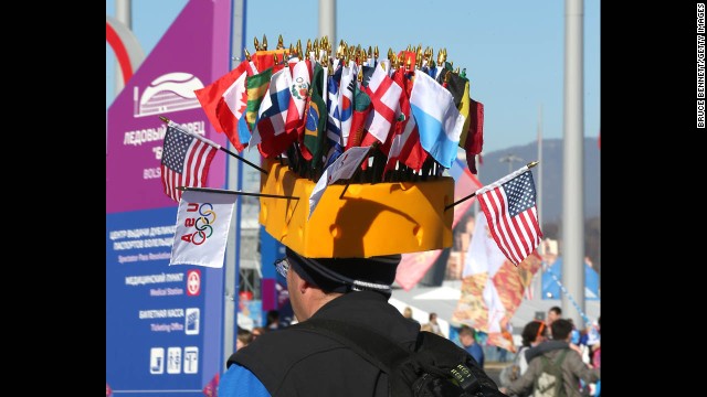 A man wears a hat adorned with the flags of different nations on February 13.
