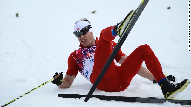 Switzerland's Dario Cologna crosses the finish line to win gold in the men's 15-kilometer classic on February 14.