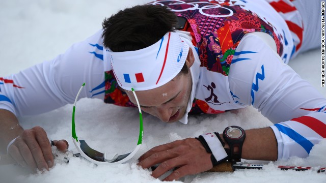 French skier Adrien Backscheider lies on the snow after the men's 15-kilometer classic.