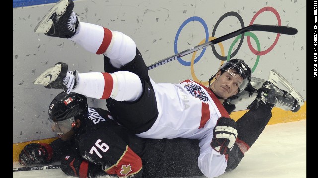 Canada's P.K. Subban, bottom, collides with Austria's Oliver Setzinger during the men's ice hockey game on February 14.