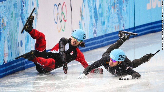 Canada's Charles Hamelin crashes, taking out American Eduardo Alvarez during the quarterfinals of the 1,000-meter short track speedskating event.