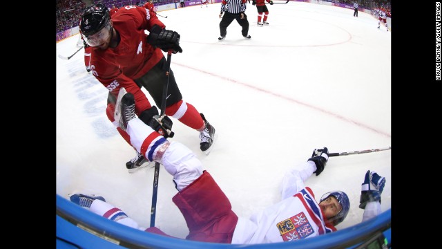 Petr Nedved of the Czech Republic falls to the ice after being checked by Switzerland's Yannick Weber during the men's hockey game on February 15.