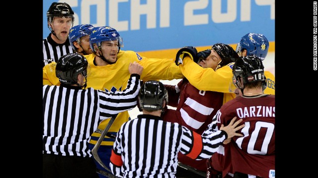 Tempers flare late in the third period as Swedish hockey forward Jimmie Ericsson, left, grabs the face of Latvian defenseman Sandis Ozolinsh on February 15.