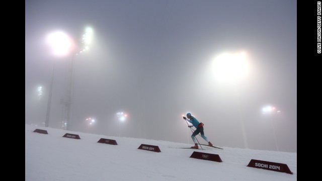 A biathlete warms up for the men's 15-kilometer mass start event on February 16.