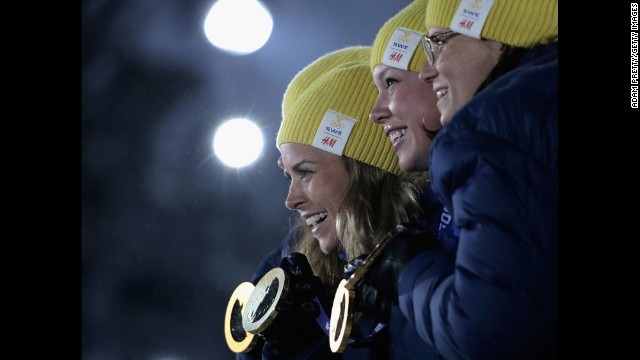 The Swedish team celebrates taking the gold in the women's cross-country relay on February 16. 