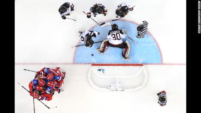 The women's hockey team from Russia, in red, celebrates a goal against Japan on February 16.