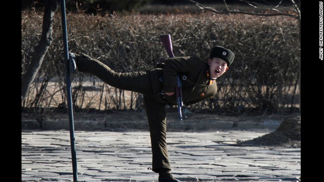 A North Korean soldier kicks a pole along the banks of the Yalu River on Tuesday, February 4.