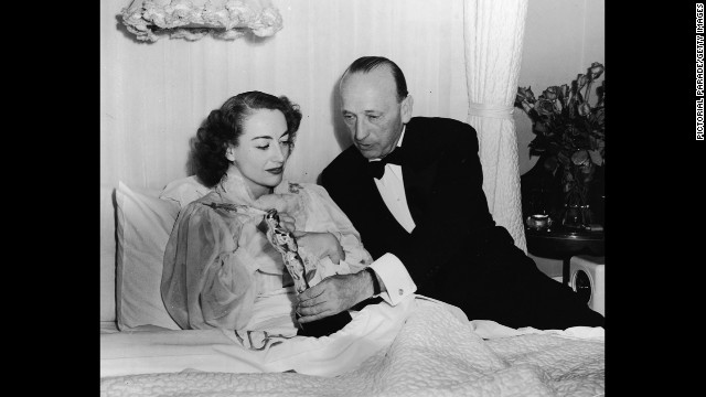 Joan Crawford receives her Academy Award in bed because of an illness. She was recognized for her performance in the 1945 film "Mildred Pierce."