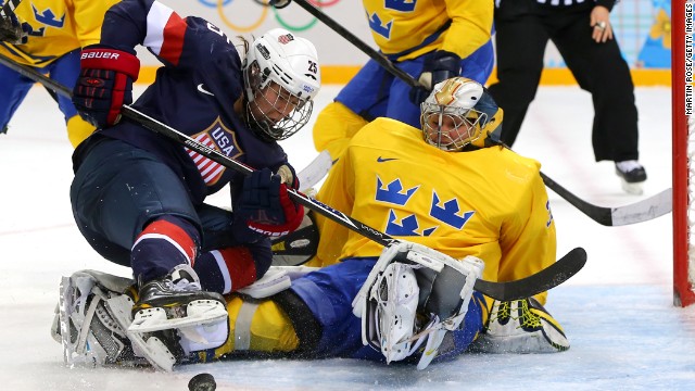 Women's hockey player Alex Carpenter of the United States tries to shoot against Valentina Lizana Wallner of Sweden during their semifinal game February 17.