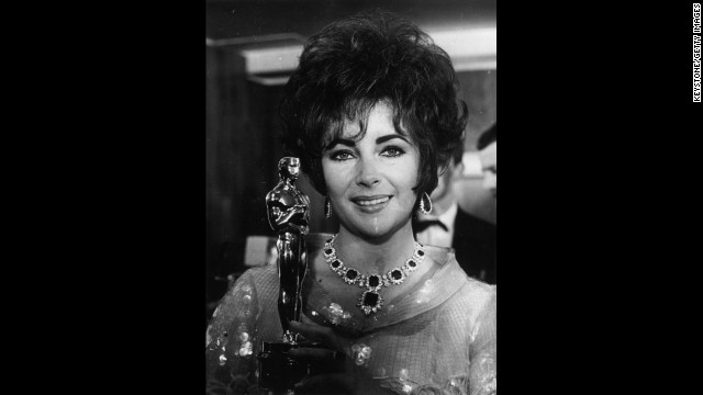 Elizabeth Taylor holds up her second Oscar, this one for the film "Who's Afraid of Virginia Woolf."