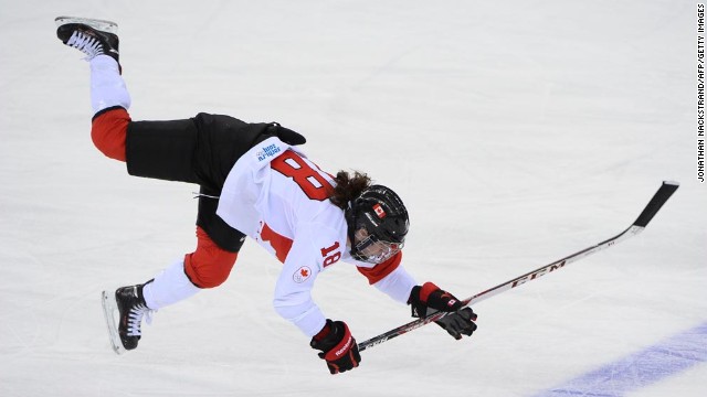 Canadian hockey player Catherine Ward falls after she was hit in the Olympic semifinal against Switzerland on Monday, February 17. 