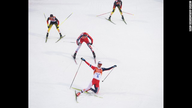 Joergen Graabak of Norway celebrates as he crosses the line to win the gold medal in the large hill Nordic combined event February 18.
