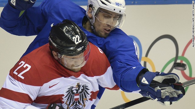 Slovenia's David Rodman, right, fights for the puck with Austria's Thomas Pock during a hockey game February 18.